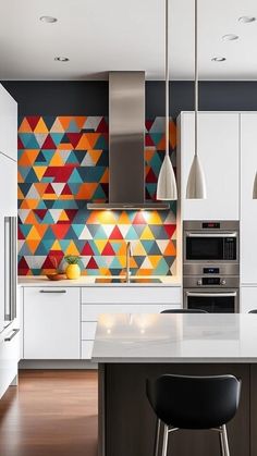 a kitchen with white cabinets and colorful wallpaper