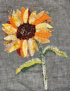 an orange and yellow flower painted on fabric