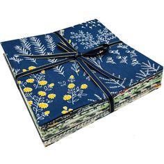 a stack of blue cloths with yellow flowers on them