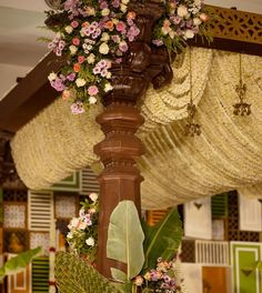 an elaborate canopy decorated with flowers and greenery