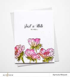 a white card with pink flowers on it and the words just a note to say