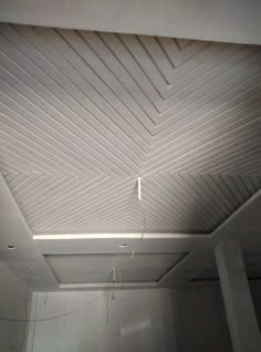 an unfinished ceiling in a room with white walls