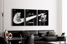 two black and white pictures hanging on the wall above a couch in a living room