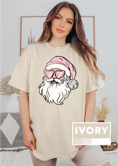 Disco Santa Comfort Colors Shirt, Pink Santa Shirt, Preppy Christmas T-Shirt, Funny Holiday Outfit, Retro Hippy Santa Shirt for Christmas ----- How To Order----- * Please, check and review all photos. Color and size charts are attached to each design. * Choose your t-shirt style, size and color * Click add to cart. You can go back to add more product * Click "Proceed to check out" Backside design is additional fee, please make sure to contact seller. If you want to add or change anything on the existing design that we show in the display picture, please contact with the seller from message box to ask if the changes and additional request can be done or not, if you do not ask and request for it without asking in the order, we will ship the item as it is without the requests done. Messages w Disco Santa, Outfit Retro, Pink Santa, Preppy Christmas, Santa Sweatshirt, Santa Shirt, Funny Holiday, Santa Shirts, Display Picture