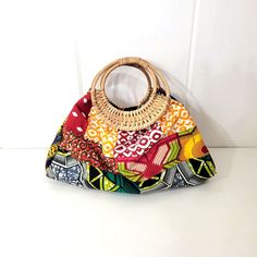 Multicolored Quilted Fabric Purse With Rattan Handles Boho Style With Small Tethered Zippered Coin Purse. It Measures 18" X 7" X 10". It Is In Very Good, Condition. It Looks Unused. Multicolor Fabric Bags For Vacation, Multicolor Fabric Vacation Bags, Multicolor Summer Shoulder Bag With Bamboo Handle, Multicolor Bamboo Handle Shoulder Bag For Summer, Multicolor Tote Shoulder Bag With Bamboo Handle, Fabric Purse, Fabric Purses, Quilted Fabric, African Jewelry