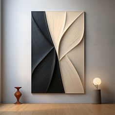 an abstract painting hangs on the wall next to a vase and lamp in a room