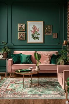 a living room with green walls, pink couches and potted plants on the floor