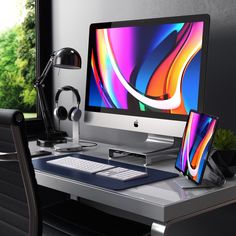 a desktop computer sitting on top of a desk next to a monitor and headphones