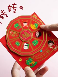 a person holding up a red card with chinese characters on it and the words happy new year written in english