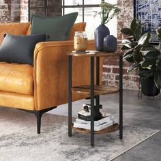 a living room with a couch, table and potted plants on the side tables