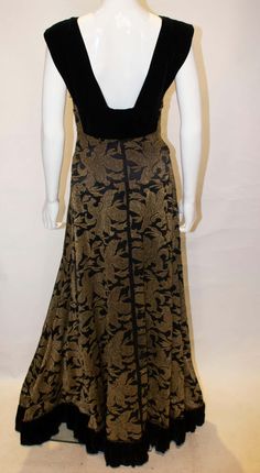 For Sale on 1stDibs - A headturning vintage evning gown in a heavy black and gold fabric with black velvet trim. The dress has black velvet strap and hem and a side zip. Gold Black Dress, Black And Gold Fabric, 1950s Clothes, 1950s Outfits, Black Evening Gown, Gold And Black Dress, Velvet Trim, Gold Fabric, Black And Gold