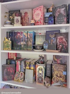 a book shelf filled with lots of books on top of white shelving unit shelves