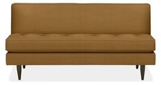 a brown couch sitting on top of a white floor