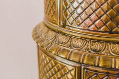 an ornate gold vase is shown against a white background