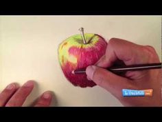 someone is drawing an apple with colored pencils