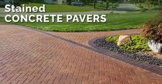 a brick driveway with the words stained concrete pavers