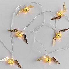 three gold angel lights are hanging from strings