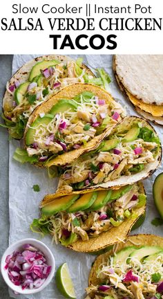 chicken tacos with coleslaw and avocado in the middle on a sheet of paper