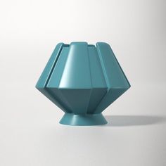 a blue vase sitting on top of a white table