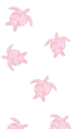 four pink sea turtles swimming in the ocean