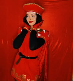 a woman dressed in red is posing for the camera