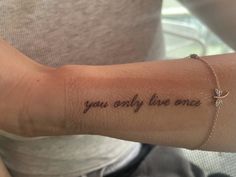 a woman's arm with the words you only live once tattooed on her left arm