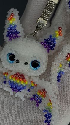 a beaded keychain with a white bear on it's face and colorful beads