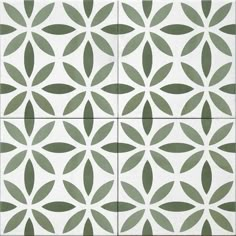 an artistic tile design in green and white with leaves on the tiles, as well as circles