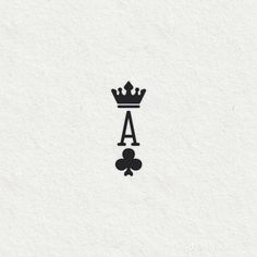 a black and white drawing of a crown on top of a piece of paper with the letter