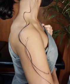 a woman with a tattoo on her shoulder