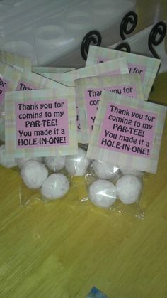 three bags with thank you for coming to my parking lot and one bag filled with golf balls