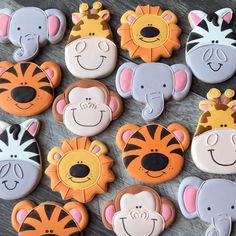 many decorated cookies with animals and zebras on top of each cookie, all in different colors