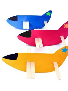 three popsicles shaped like airplanes with stars on them