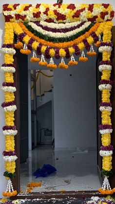 a mirror decorated with flowers and garlands