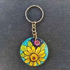 a key chain with a flower painted on it