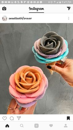 someone is holding up two fake flowers made out of doughnuts that look like roses