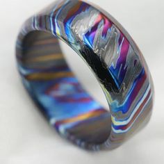 a close up of a colorful ring on a white surface with no people around it