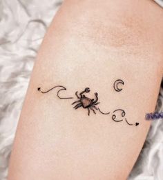 a tattoo on the arm of a woman with a spider and moon in the background