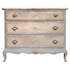 an old chest of drawers with knobs on the top and bottom, painted white