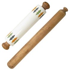 two wooden mallets are next to each other and one is white with multicolored arrows on it