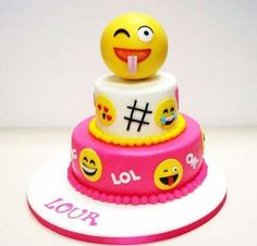 a three tiered cake decorated with smiley faces