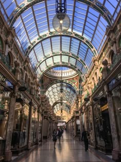 the inside of a shopping mall with people walking around