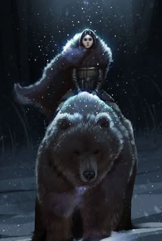 a woman sitting on top of a bear in the snow