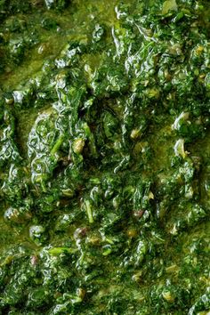 spinach and other greens in a pan ready to be mixed into soup or stew