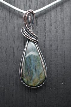 Labradorite stone, hand wrapped in patinated copper wire. Rustic Wire Wrapped Copper Jewelry, Jewelry Mood Board, Spokane Wa, Wrapped Jewelry, Hand Wrap, Oval Stone, Labradorite Pendant, Labradorite Stone