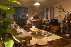 a living room filled with furniture and lots of windows