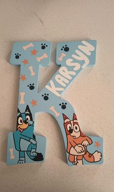 the letter k is made up of cartoon characters and has an image of a fox