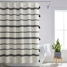 a shower curtain with black and white stripes