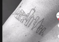 a city skyline tattoo on the arm