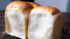 two loaves of bread sitting on top of a cooling rack